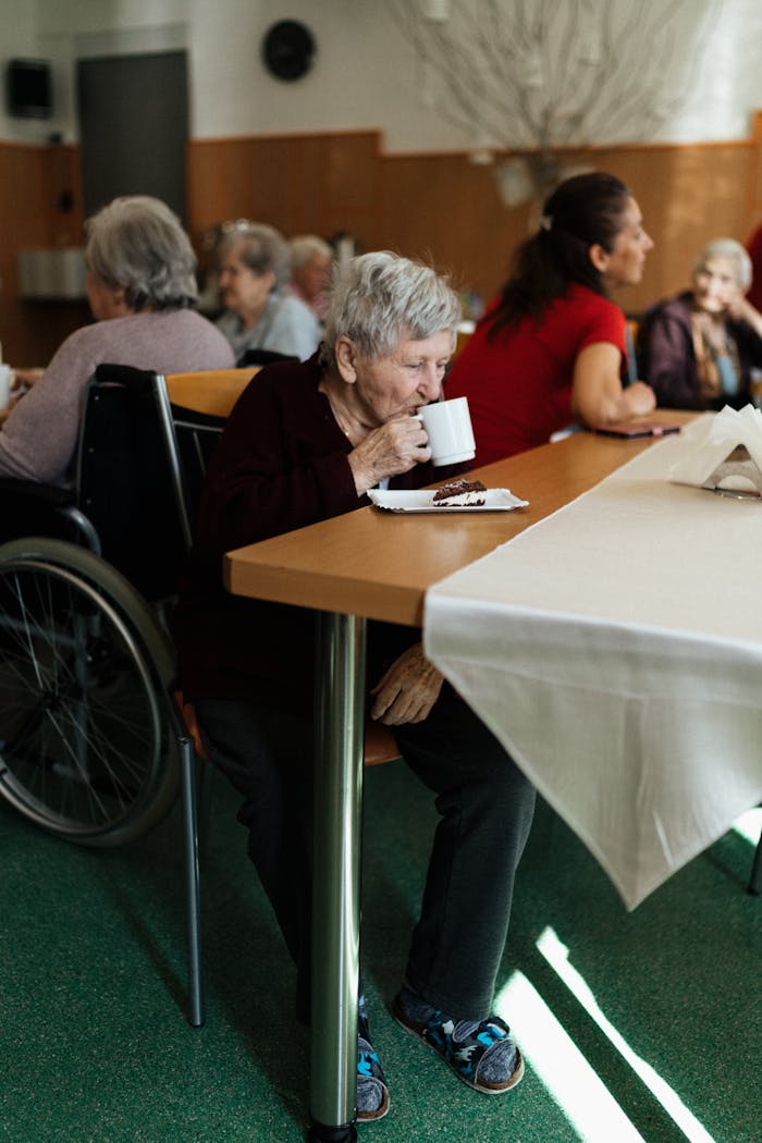Elderly group enjoying tea and cake in a senior community center in Karviná.
